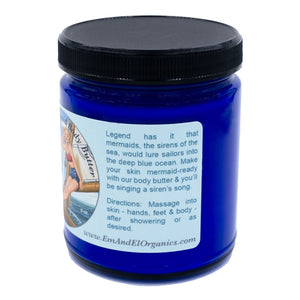 8 oz blue glass jar containing organic body butter with shea butter and jojoba oil and pure essential oils
