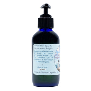 4 oz Blue glass bottle of organic body oil with jojoba oil and apricot kernel oil