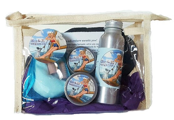 Travel skin care set with facial toner, face moisturizer, hand cream, sleep mask, earplugs in a clear plastic travel bag